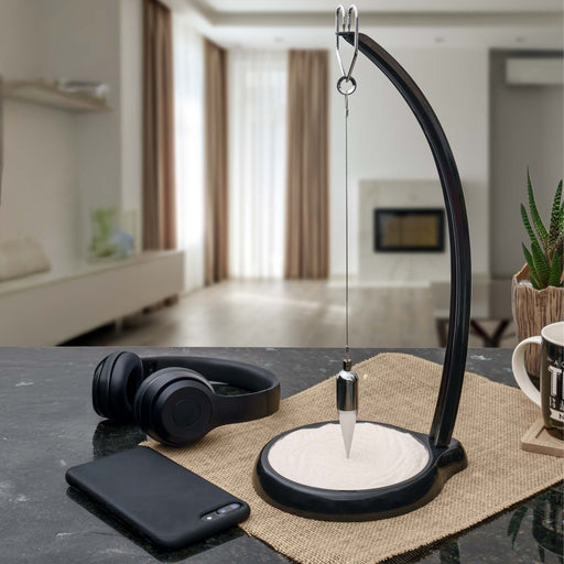 Modern Foucault Pendulum decorative items in a home office.